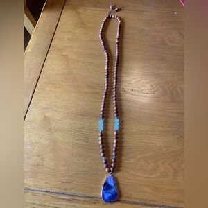 Wood and glass beaded necklace, with semi precious purple pendant.